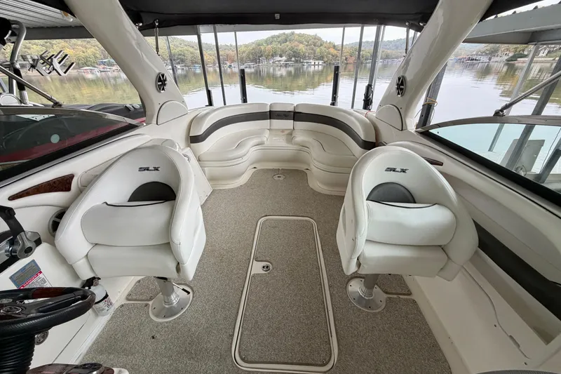 Slide: The Image of 2007 Sea Ray 290 SLX boat dashboard with wood accents and steering wheel. - 6