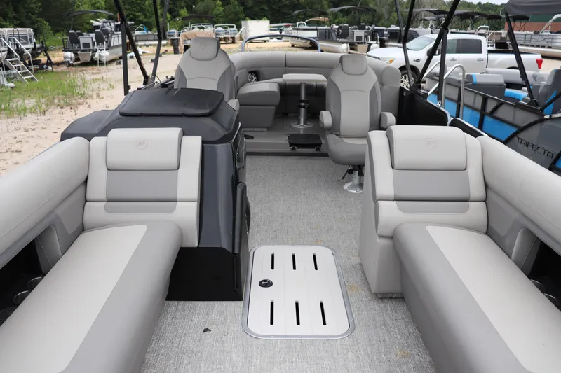 Slide: The Image of 2024 Premier 250 Solaris Rev pontoon boat interior with luxurious seating and modern design. - 1