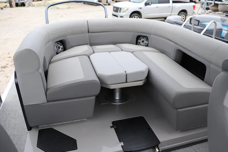Slide: The Image of 2024 Premier 250 Solaris Rev pontoon boat with luxurious gray seating and integrated speakers. - 7