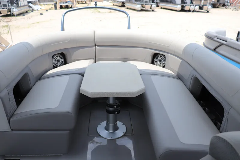 Slide: The Image of 2024 Premier 250 Solaris Rev boat interior with gray seating and central table. - 8