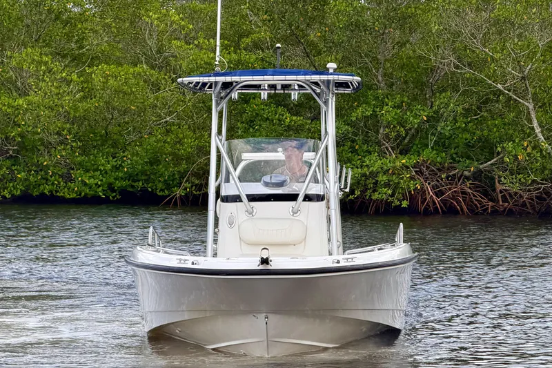 Slide: The Image of 2009 Boston Whaler 230 Dauntless boat navigating through lush mangroves. - 1