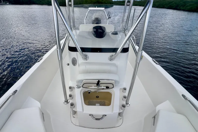 Slide: The Image of 2009 Boston Whaler 230 Dauntless boat interior with console and seating on calm water. - 10