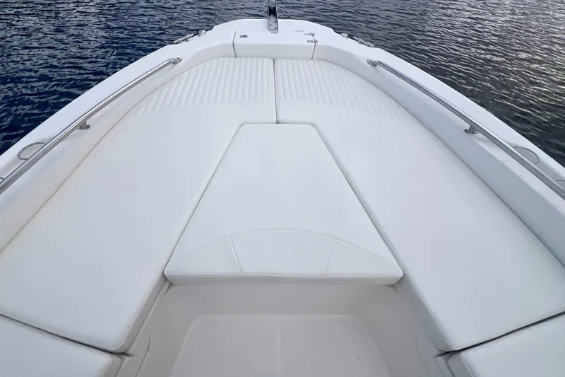 Slide: The Image of 2009 Boston Whaler 230 Dauntless boat deck with white cushioned seating. - 14