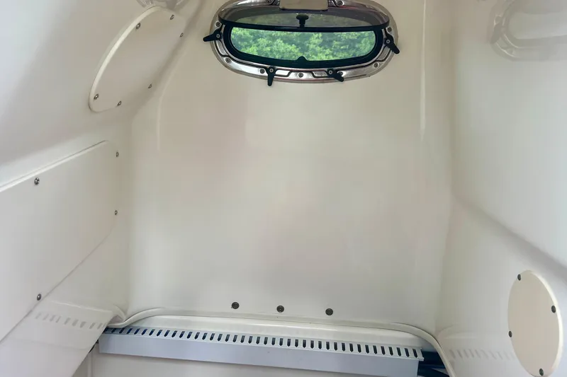 Slide: The Image of Interior cabin of 2009 Boston Whaler 230 Dauntless boat with porthole window. - 21