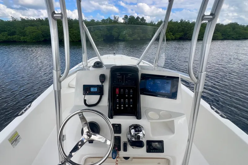 Slide: The Image of 2009 Boston Whaler 230 Dauntless boat console with steering wheel and navigation equipment. - 5