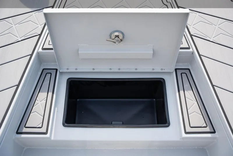 Slide: The Image of Open storage compartment on 2026 Avid 23 Mag boat deck. - 10