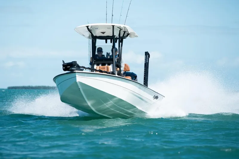 Slide: The Image of Avid 23 Mag 2026 boat speeding on open water, creating splashes. - 4