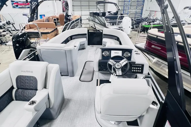 Slide: The Image of 2025 Harris Solstice 250 pontoon boat interior with luxurious seating and modern dashboard. - 16
