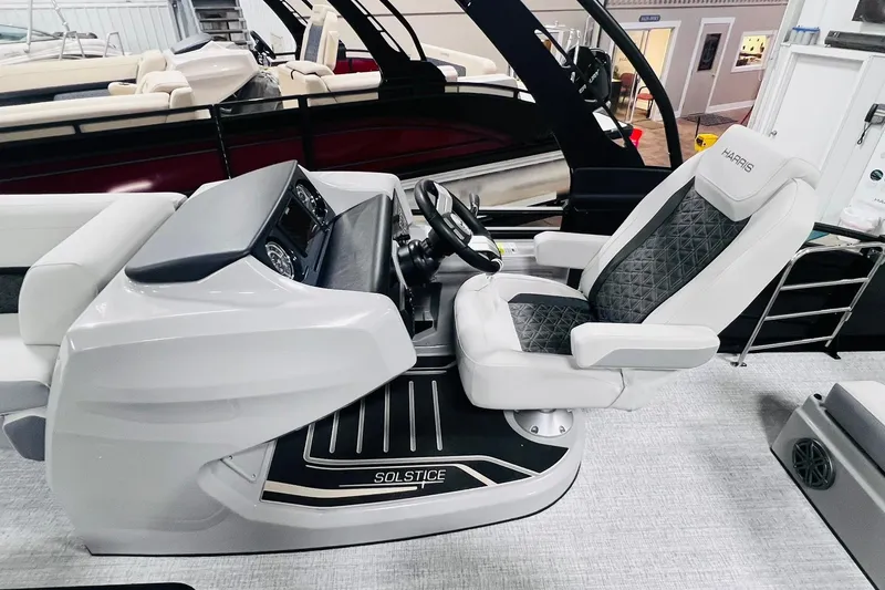 Slide: The Image of 2025 Harris Solstice 250 boat interior with sleek helm and luxurious captain's chair. - 25