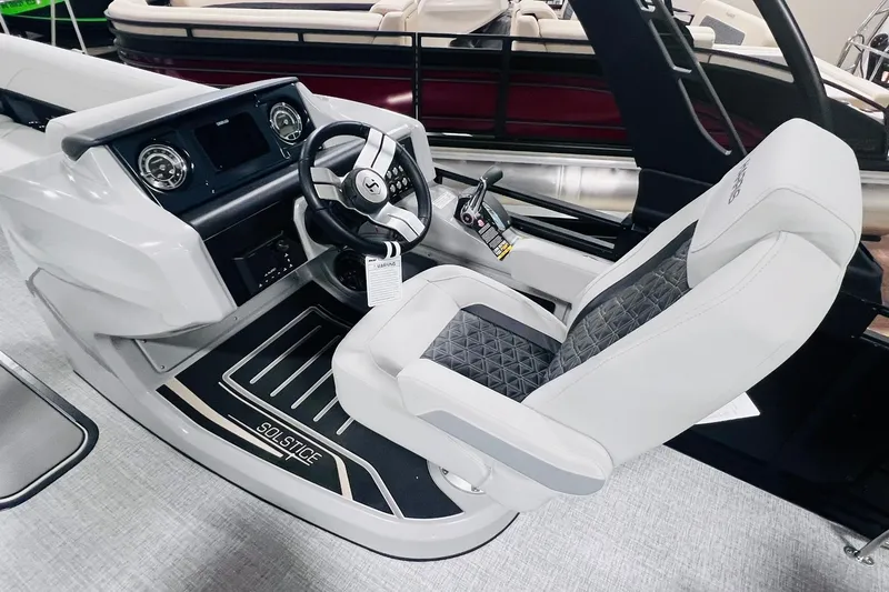 Slide: The Image of 2025 Harris Solstice 250 boat cockpit with modern steering and luxurious seating. - 26