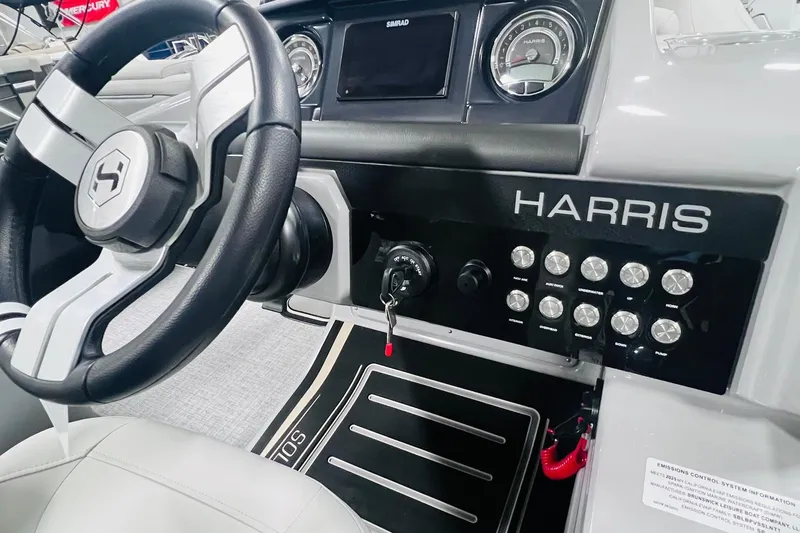 Slide: The Image of Interior of 2025 Harris Solstice 250 boat, featuring steering wheel and control panel. - 29