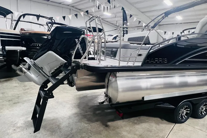 Slide: The Image of 2025 Harris Solstice 250 pontoon boat with Mercury outboard motor in showroom. - 45