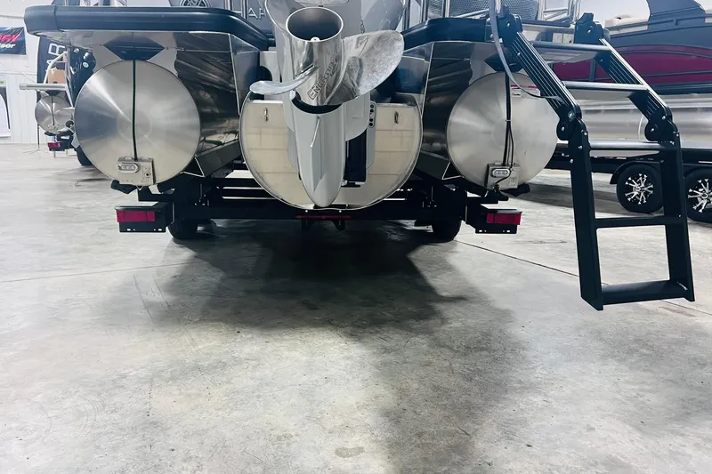 Slide: The Image of 2025 Harris Solstice 250 pontoon boat rear view with ladder and propeller in showroom. - 46