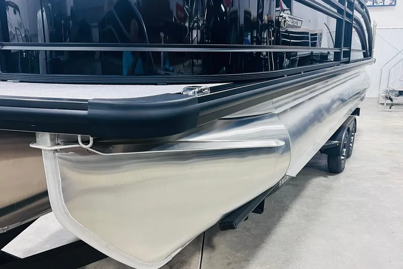 Slide: The Image of 2025 Harris Solstice 250 pontoon boat, sleek design, silver exterior, displayed indoors. - 49
