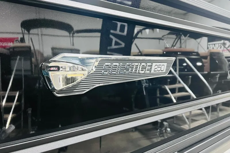 Slide: The Image of 2025 Harris Solstice 250 emblem on sleek black surface. - 53