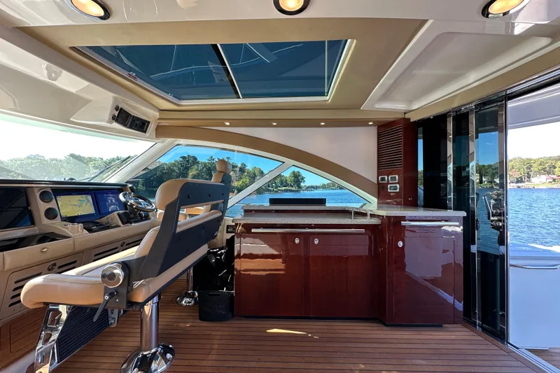 Slide: The Image of Luxurious 2007 Sea Ray 60 Sundancer yacht interior with modern helm and panoramic windows. - 12