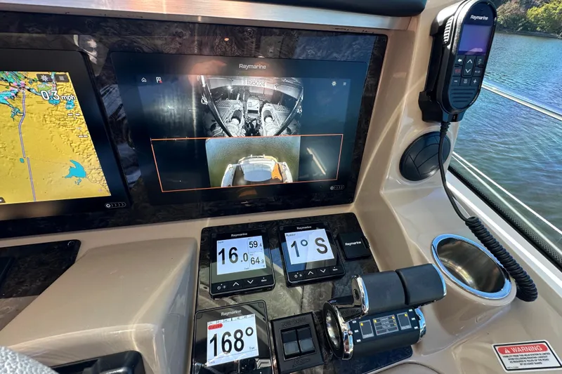 Slide: The Image of Control panel of a 2007 Sea Ray 60 Sundancer with navigation and monitoring screens. - 16