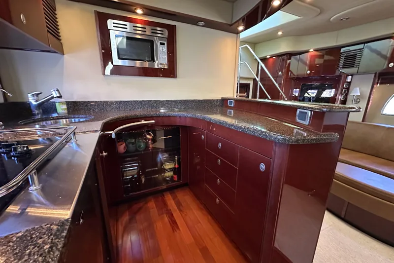 Slide: The Image of Luxurious 2007 Sea Ray 60 Sundancer yacht kitchen with modern appliances and elegant wood finishes. - 23