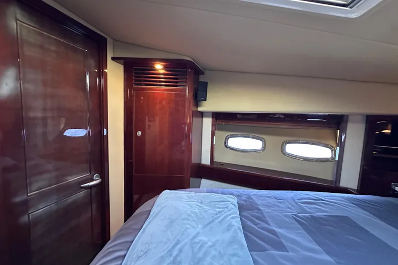Slide: The Image of Luxurious 2007 Sea Ray 60 Sundancer cabin interior with wood finishes and porthole windows. - 35