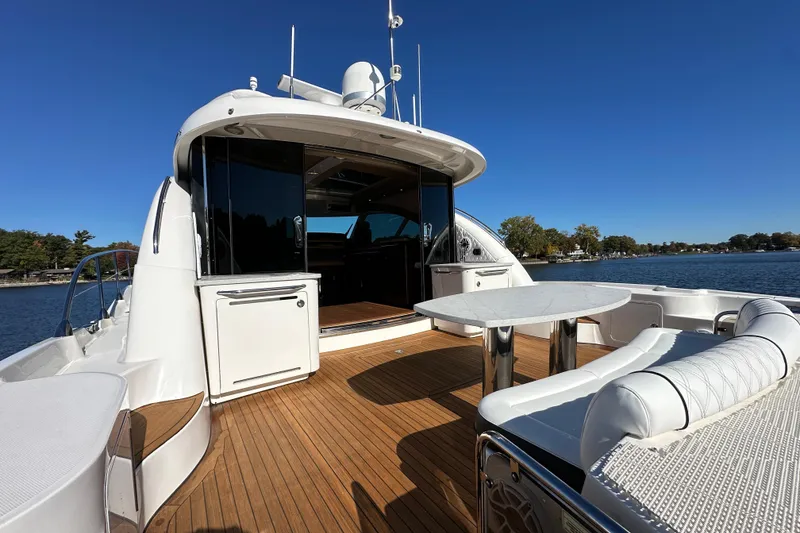 Slide: The Image of 2007 Sea Ray 60 Sundancer yacht with spacious deck and seating, cruising on a sunny day. - 4