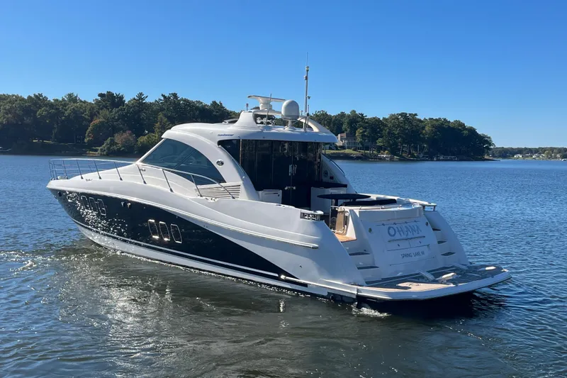 Slide: The Image of 2007 Sea Ray 60 Sundancer yacht cruising on a serene lake under a clear blue sky. - 40
