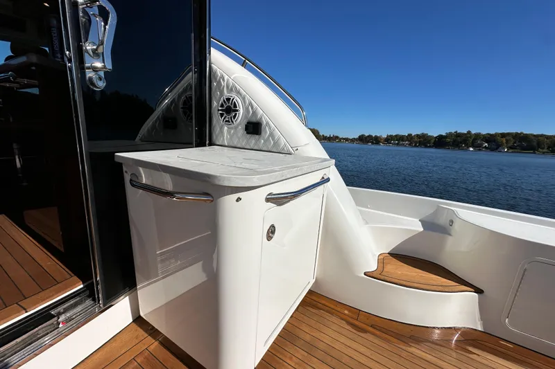 Slide: The Image of 2007 Sea Ray 60 Sundancer yacht deck with sleek design and scenic water view. - 8