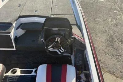 Slide: The Image of 2024 Skeeter FXR21 FLEX boat interior with steering wheel and seating. - 7