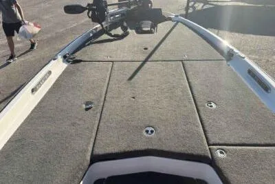 Slide: The Image of 2024 Skeeter FXR21 FLEX boat deck with carpeted surface and fishing equipment. - 8