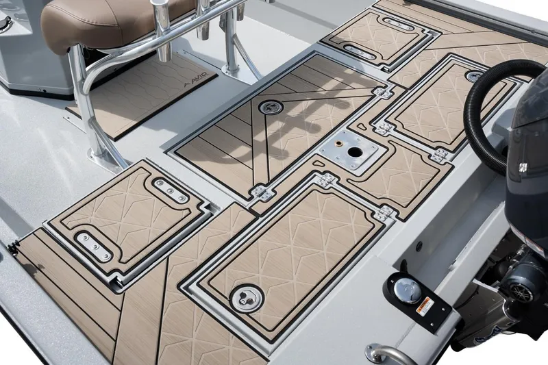 Slide: The Image of 2026 Avid 23 Fusion boat deck with tan non-slip surface and storage compartments. - 14