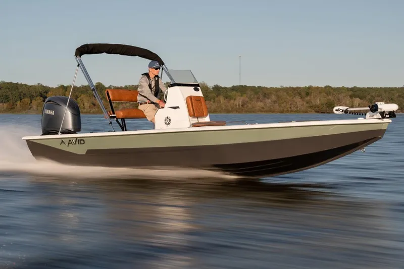 Slide: The Image of 2026 Avid 23 Fusion boat cruising on a lake with Yamaha engine. - 3