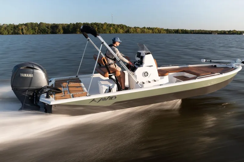 Slide: The Image of 2026 Avid 23 Fusion boat speeding on a lake with Yamaha engine. - 4