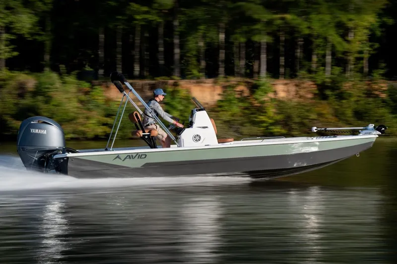 Slide: The Image of 2026 Avid 23 Fusion boat speeding on a lake with Yamaha engine. - 5