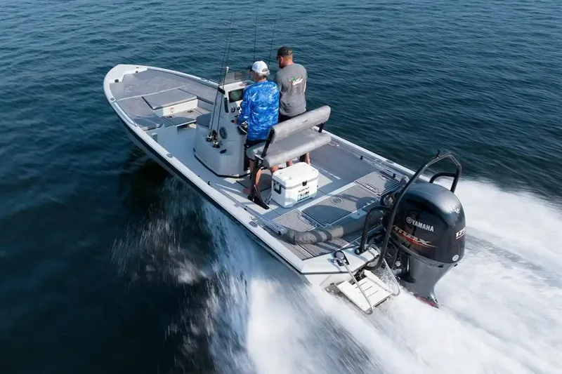 Slide: The Image of Avid 23 Fusion 2026 boat cruising on water with two people onboard. - 7