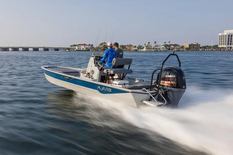 Slide: The Image of Avid 23 Fusion 2026 boat cruising on water with Yamaha engine. - 9