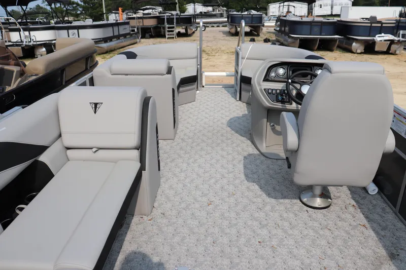 Slide: The Image of 2025 Trifecta 22 C LE pontoon boat interior with plush seating and modern helm. - 8