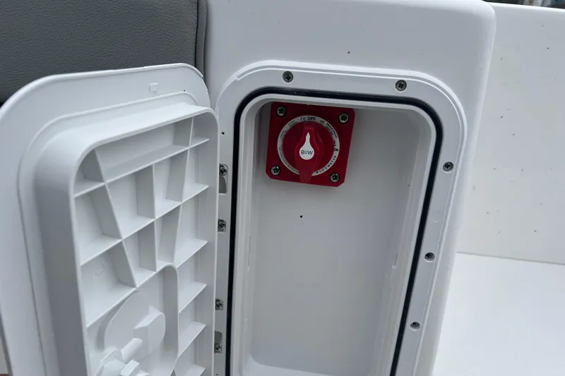 Slide: The Image of Battery switch compartment on 2026 Cape Horn 22 OS boat, featuring a red switch. - 16