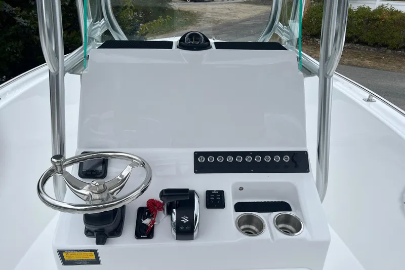 Slide: The Image of 2026 Cape Horn 22 OS boat console with steering wheel and controls. - 2
