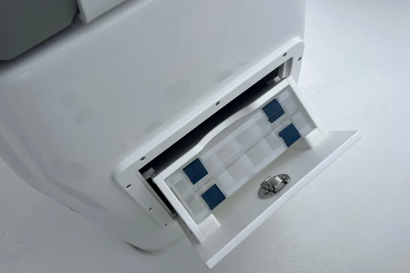 Slide: The Image of Cape Horn 22 OS 2026 model, featuring a white storage compartment with latch. - 13