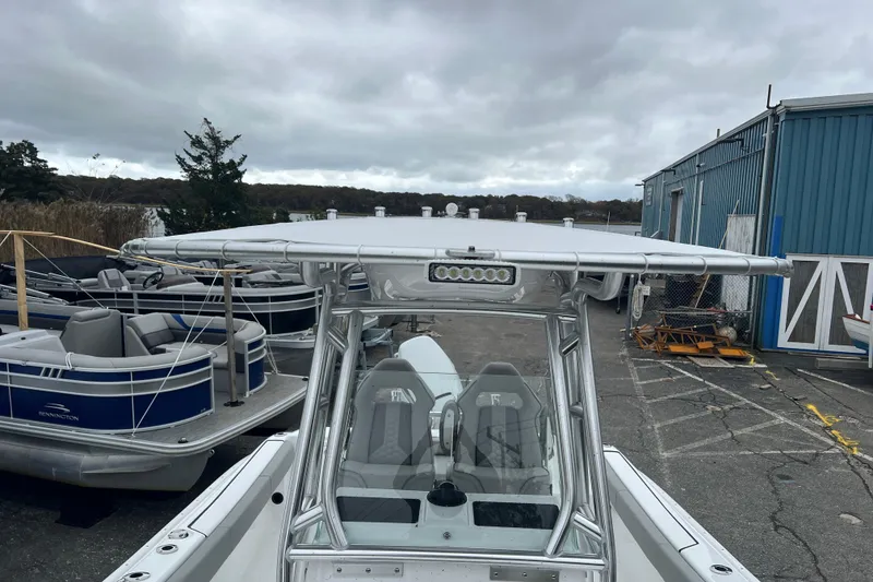 Slide: The Image of 2026 Cape Horn 22 OS boat docked near other vessels under cloudy skies. - 17