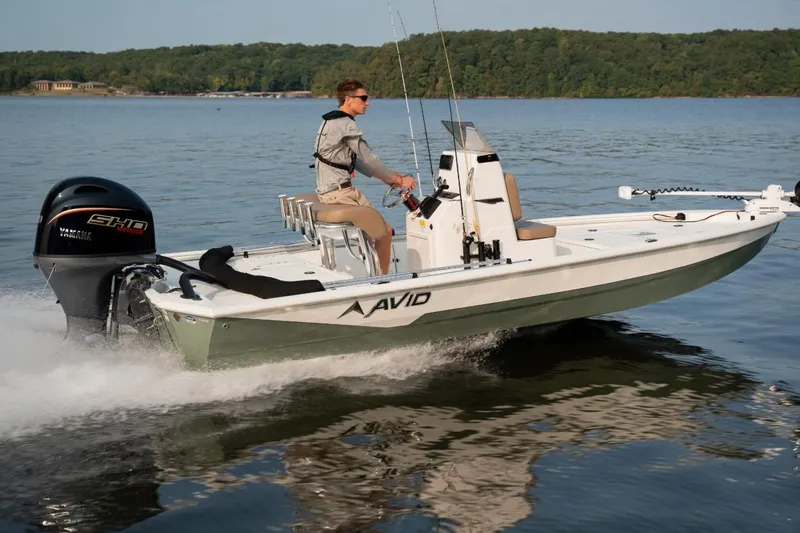 Slide: The Image of Open storage compartment in 2026 Avid 19 FSX boat, featuring a turquoise interior. - 16