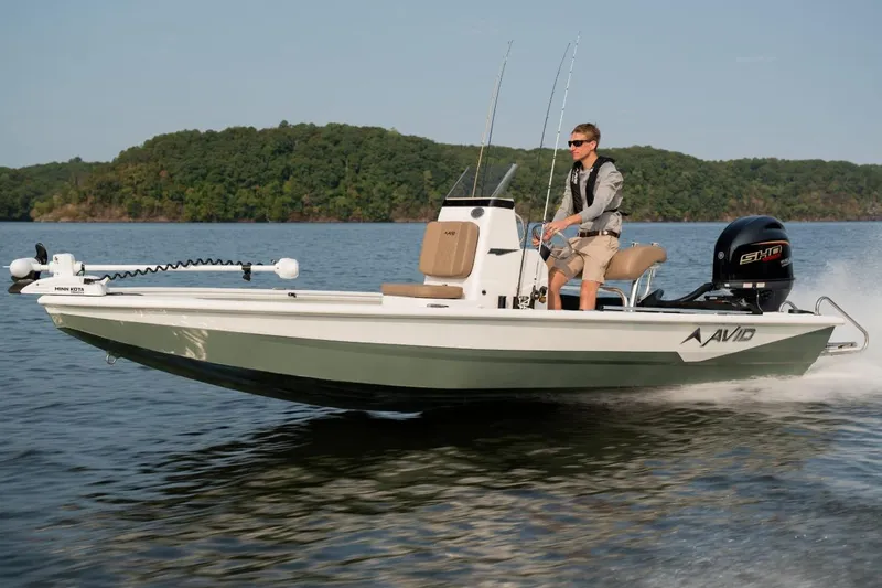 Slide: The Image of 2026 Avid 19 FSX boat console with steering wheel and control panel. - 19