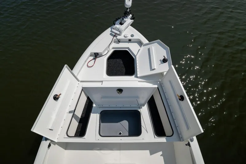 Slide: The Image of Avid 19 FSX 2026 boat dashboard with open storage compartment and control panel. - 22