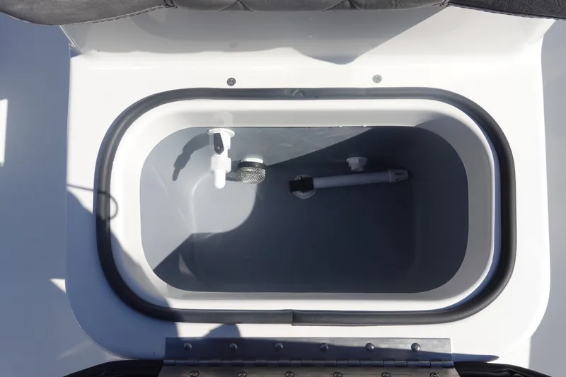 Slide: The Image of Livewell compartment in 2026 Avid 19 FSX boat, featuring plumbing and drainage system. - 24