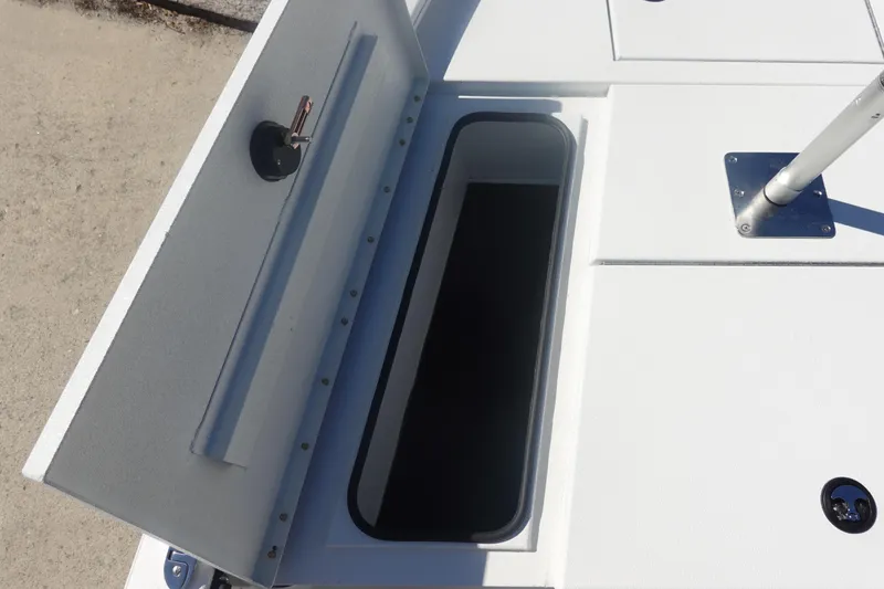Slide: The Image of Open storage compartment on 2026 Avid 19 FSX boat deck. - 28