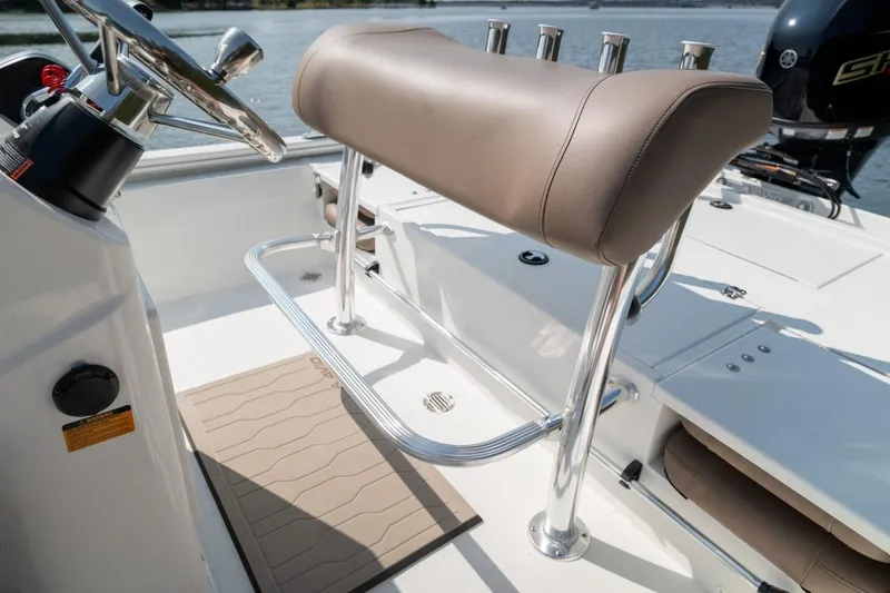 Slide: The Image of 2026 Avid 19 FSX boat interior with gray seating and fishing rod holders. - 9