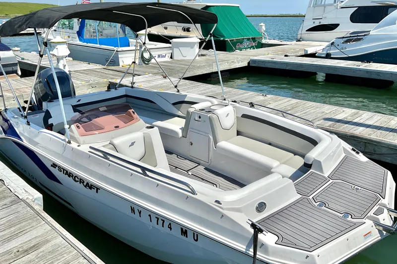 The Image of 2023 Starcraft SVX 191 OB boat docked at marina, featuring sleek design and spacious seating. - 1