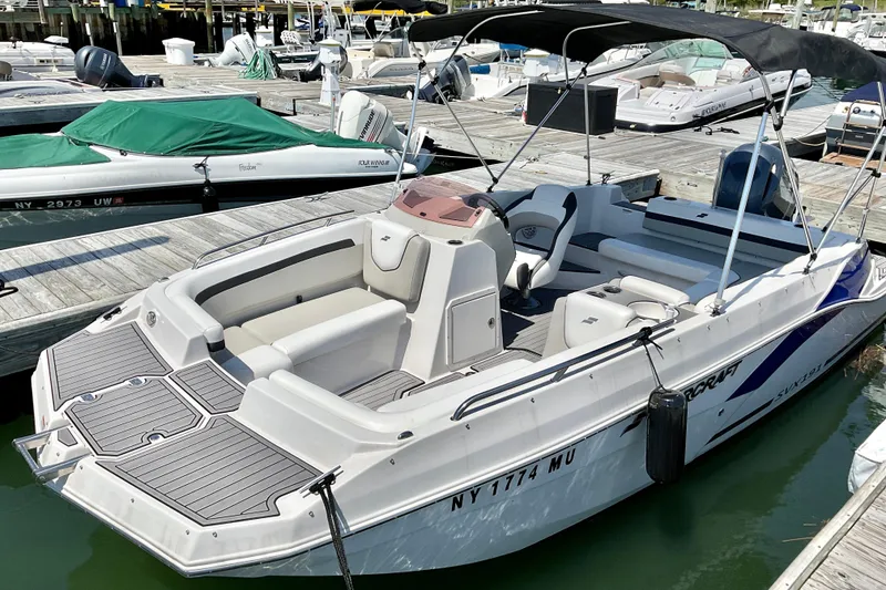Slide: The Image of 2023 Starcraft SVX 191 OB boat docked at marina, featuring sleek design and spacious seating. - 4