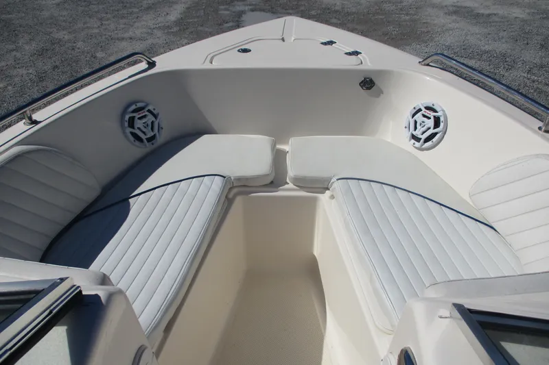 Slide: The Image of 2006 Key West 186 Dual Console boat interior with white cushioned seating and speakers. - 7