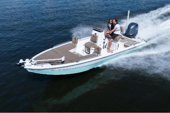 The Image of Avid 21 Fusion 2026 boat speeding on open water with two passengers. - 1