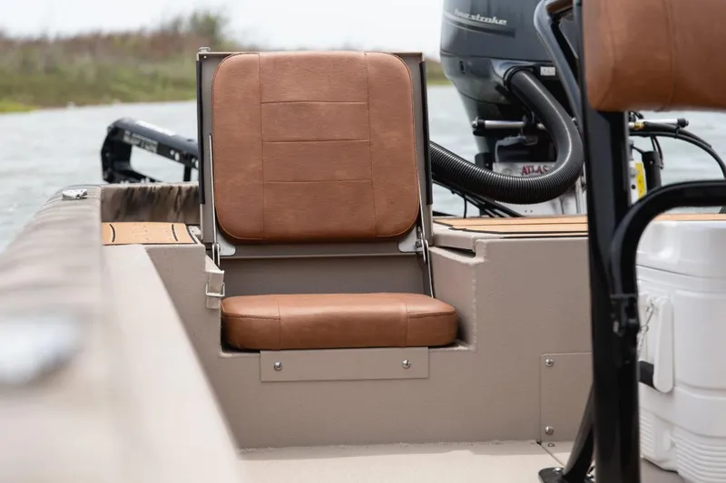 Slide: The Image of Avid 21 Fusion 2026 boat seat with brown leather upholstery and motor in background. - 13